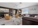 Spacious living room features a large sectional sofa, comfortable seating, and bright natural light at 9621 E Calgary Ave, Sun Lakes, AZ 85248