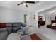 Bright living room with gray leather sectional and a glass coffee table at 9621 E Calgary Ave, Sun Lakes, AZ 85248