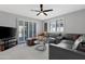 Cozy living room with sliding glass doors and a comfortable gray leather sectional at 9621 E Calgary Ave, Sun Lakes, AZ 85248