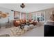 Comfortable living room with a leather sectional, neutral walls, and a decorative area rug at 9621 E Calgary Ave, Sun Lakes, AZ 85248