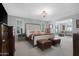 Spacious bedroom with a king-sized bed, comfortable seating, and bright natural light at 9621 E Calgary Ave, Sun Lakes, AZ 85248