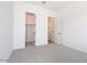Neutral carpeted bedroom with two closets and white walls at 10022 S 37Th Ave, Laveen, AZ 85339