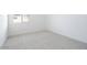 Bright bedroom with neutral carpet, white walls, and natural light at 10022 S 37Th Ave, Laveen, AZ 85339