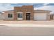 Charming single-story home featuring a stacked stone entry and a two car garage at 10022 S 37Th Ave, Laveen, AZ 85339