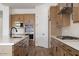 Bright kitchen boasting stainless steel appliances, light countertops, and wood cabinets at 10022 S 37Th Ave, Laveen, AZ 85339