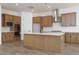 Modern kitchen featuring wood cabinets, a stainless steel range hood, and a large island at 10022 S 37Th Ave, Laveen, AZ 85339