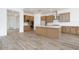 Well-lit kitchen with stainless steel appliances, island, and ample wood cabinet space at 10022 S 37Th Ave, Laveen, AZ 85339