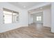 Bright and airy living room featuring light wood-look tile flooring, white walls and trim, with open doorway at 10022 S 37Th Ave, Laveen, AZ 85339