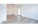 Bright, open living room featuring wood-look tile flooring, white walls and trim, with a glass door entryway at 10022 S 37Th Ave, Laveen, AZ 85339