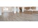 Open floor plan with wood-look tile floors extending from the living area to the kitchen at 10022 S 37Th Ave, Laveen, AZ 85339