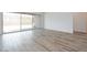 Bright living area featuring wood-look tile floors and a sliding glass door to the patio at 10022 S 37Th Ave, Laveen, AZ 85339