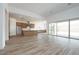 Spacious living area adjacent to kitchen featuring wood-look tile floors and natural light at 10022 S 37Th Ave, Laveen, AZ 85339