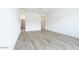 Spacious main bedroom with wood-look tile floors, white walls, and neutral tones at 10022 S 37Th Ave, Laveen, AZ 85339