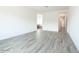 Spacious main bedroom with wood-look tile floors, white walls, and neutral tones at 10022 S 37Th Ave, Laveen, AZ 85339