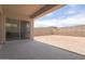 Covered patio with concrete slab and sliding glass doors overlooking the fenced backyard at 10022 S 37Th Ave, Laveen, AZ 85339