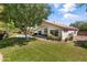 Expansive backyard with a pool, patio, lush greenery, and mature trees at 108 E Horseshoe Ave, Gilbert, AZ 85296