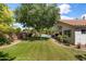 Mature landscaped backyard featuring a pool, grass, patio, and mature trees at 108 E Horseshoe Ave, Gilbert, AZ 85296