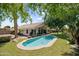 Aerial view of backyard featuring a sparkling pool, mature trees, and a covered patio at 108 E Horseshoe Ave, Gilbert, AZ 85296