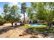 Wide angle image of home's backyard pool, lush trees, and desert landscaping at 108 E Horseshoe Ave, Gilbert, AZ 85296