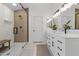 Elegant bathroom with a glass-enclosed shower, double vanity, and modern fixtures at 108 E Horseshoe Ave, Gilbert, AZ 85296