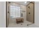 Luxurious bathroom shower with glass enclosure, bench seating, and dual shower heads at 108 E Horseshoe Ave, Gilbert, AZ 85296