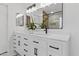 Bright bathroom features a double sink vanity with white marble countertop and black hardware, plus large mirror at 108 E Horseshoe Ave, Gilbert, AZ 85296
