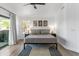 Comfortable bedroom with sliding glass door, neutral decor, carpet, and ample natural light at 108 E Horseshoe Ave, Gilbert, AZ 85296