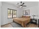 Cozy bedroom with vaulted ceilings, ceiling fan, and a view to the outdoors at 108 E Horseshoe Ave, Gilbert, AZ 85296