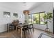 Bright dining area featuring modern table, stylish decor, a beverage cooler and a large window with views at 108 E Horseshoe Ave, Gilbert, AZ 85296
