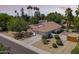 Charming single-story home with lush landscaping, a terracotta tile roof, and a spacious two-car garage at 108 E Horseshoe Ave, Gilbert, AZ 85296