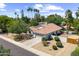 Charming single-story home with lush landscaping, a terracotta tile roof, and a spacious two-car garage at 108 E Horseshoe Ave, Gilbert, AZ 85296