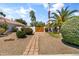 Inviting front yard with a charming walkway, lush landscaping, and mature palm trees at 108 E Horseshoe Ave, Gilbert, AZ 85296