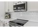 Close-up view of kitchen with stainless steel appliances, white cabinets, backsplash, and ample countertop space at 108 E Horseshoe Ave, Gilbert, AZ 85296