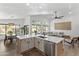 Open-concept kitchen with island, stainless appliances, and access to dining and living areas at 108 E Horseshoe Ave, Gilbert, AZ 85296