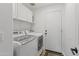 Convenient laundry room with front loading washer and dryer, plus storage at 108 E Horseshoe Ave, Gilbert, AZ 85296
