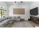 Cozy living room with a large sectional sofa, stylish fireplace, and large windows offering natural light at 108 E Horseshoe Ave, Gilbert, AZ 85296
