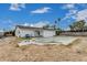 View of the backyard with an empty pool and adjacent to a white single-story home at 13039 N 19Th Ave, Phoenix, AZ 85029