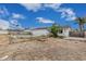 Backyard featuring an empty pool, chain link fence, sparse landscaping, and single-story white home at 13039 N 19Th Ave, Phoenix, AZ 85029