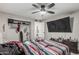 Bedroom featuring wood-look floors, ceiling fan, and closet with sliding doors at 13039 N 19Th Ave, Phoenix, AZ 85029