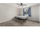 This bedroom features neutral walls, carpet flooring, a ceiling fan, and a window at 13039 N 19Th Ave, Phoenix, AZ 85029