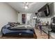 Bedroom featuring wood-look floors, ceiling fan, and closet with sliding doors at 13039 N 19Th Ave, Phoenix, AZ 85029