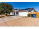 This inviting home boasts a spacious driveway and a clean, white exterior with solar panels for energy efficiency at 13039 N 19Th Ave, Phoenix, AZ 85029