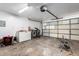 Spacious garage featuring laundry area, storage, and a convenient garage door opener at 13039 N 19Th Ave, Phoenix, AZ 85029
