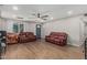 Cozy living room featuring modern flooring, a ceiling fan, and comfortable seating, perfect for relaxation at 13039 N 19Th Ave, Phoenix, AZ 85029