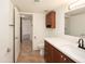 Well-lit bathroom with dark wood cabinets and a quartz countertop at 1333 E Morten Ave # 230, Phoenix, AZ 85020