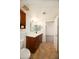 Bright bathroom featuring a single sink vanity with stained wood cabinets and tile flooring at 1333 E Morten Ave # 230, Phoenix, AZ 85020