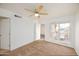 Cozy bedroom with neutral carpet, ceiling fan, a large window, and white walls at 1333 E Morten Ave # 230, Phoenix, AZ 85020