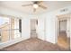 Bright bedroom with neutral carpet, ceiling fan, and a large window providing natural light at 1333 E Morten Ave # 230, Phoenix, AZ 85020