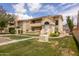 Attractive condo with red tile roof, manicured lawn, mature landscaping, and charming front entrance at 1333 E Morten Ave # 230, Phoenix, AZ 85020