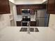 Well-equipped kitchen boasts stainless steel appliances, dark cabinetry, and bright countertops with a sink at 1333 E Morten Ave # 230, Phoenix, AZ 85020